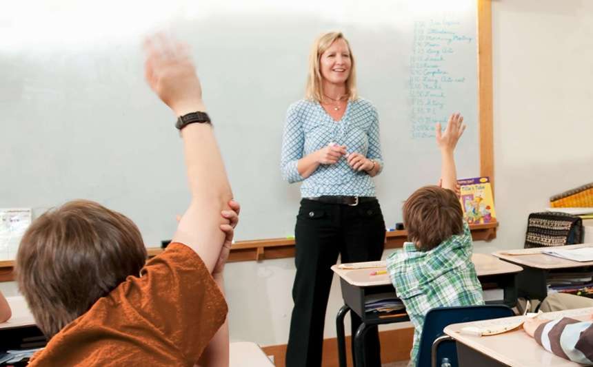 Teacher in front of classroom whiteboard