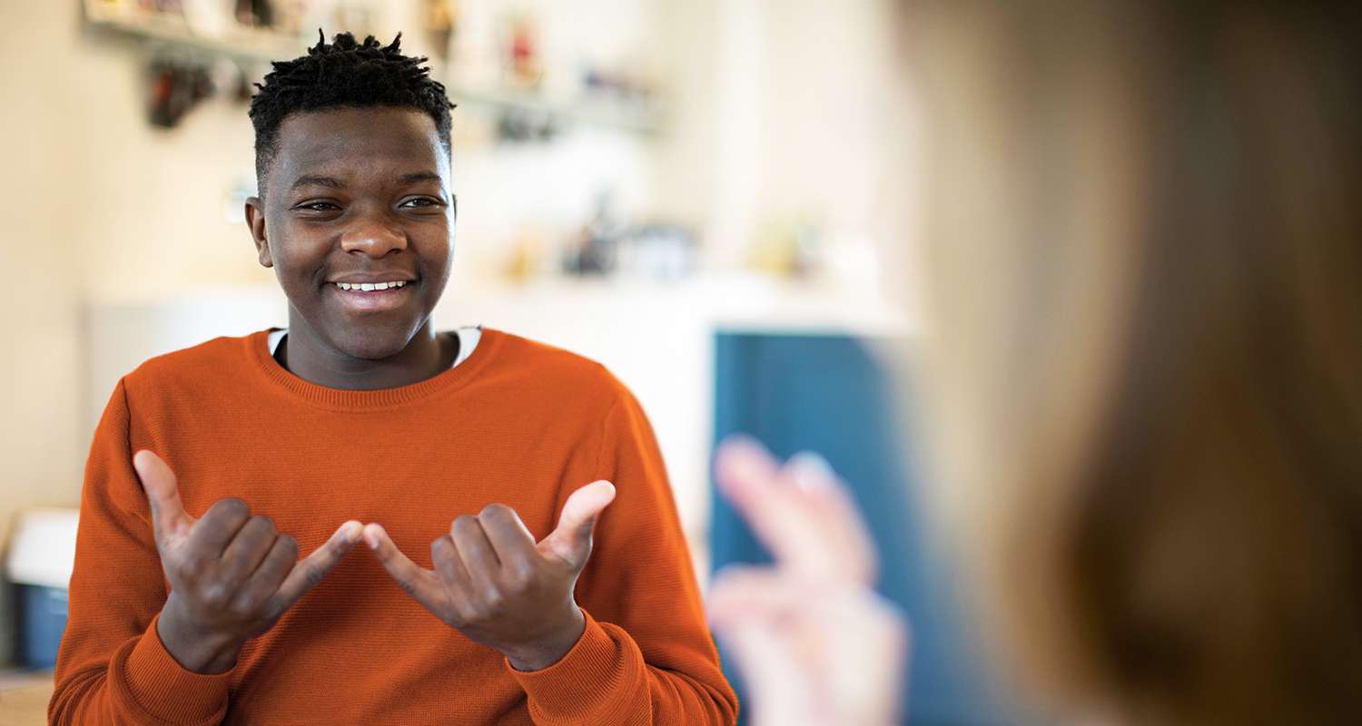 Teenager-using-sign-language-to-communicate-with-teacher