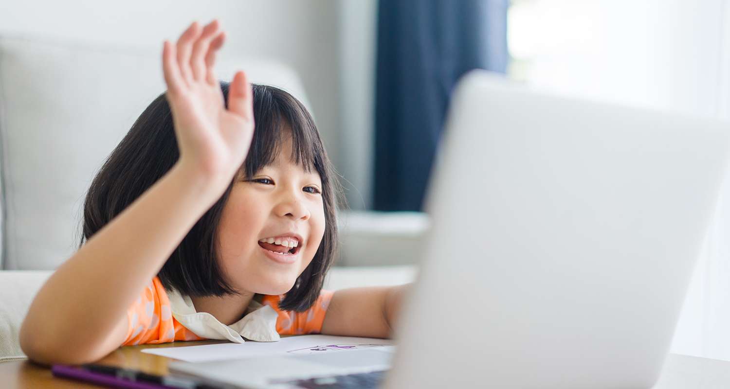 Young-girl-raising-her-hand-during-virtual-learning