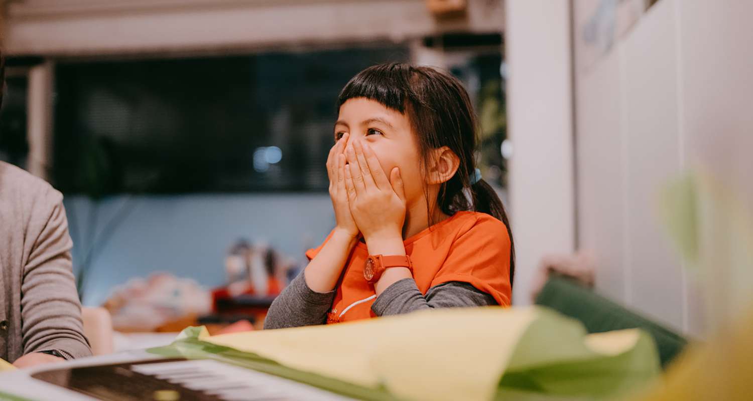 Young-girl-smiling-with-excitement-at-school