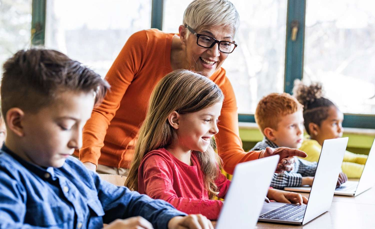 teacher with students at computers