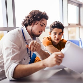 Male tutor with high school student